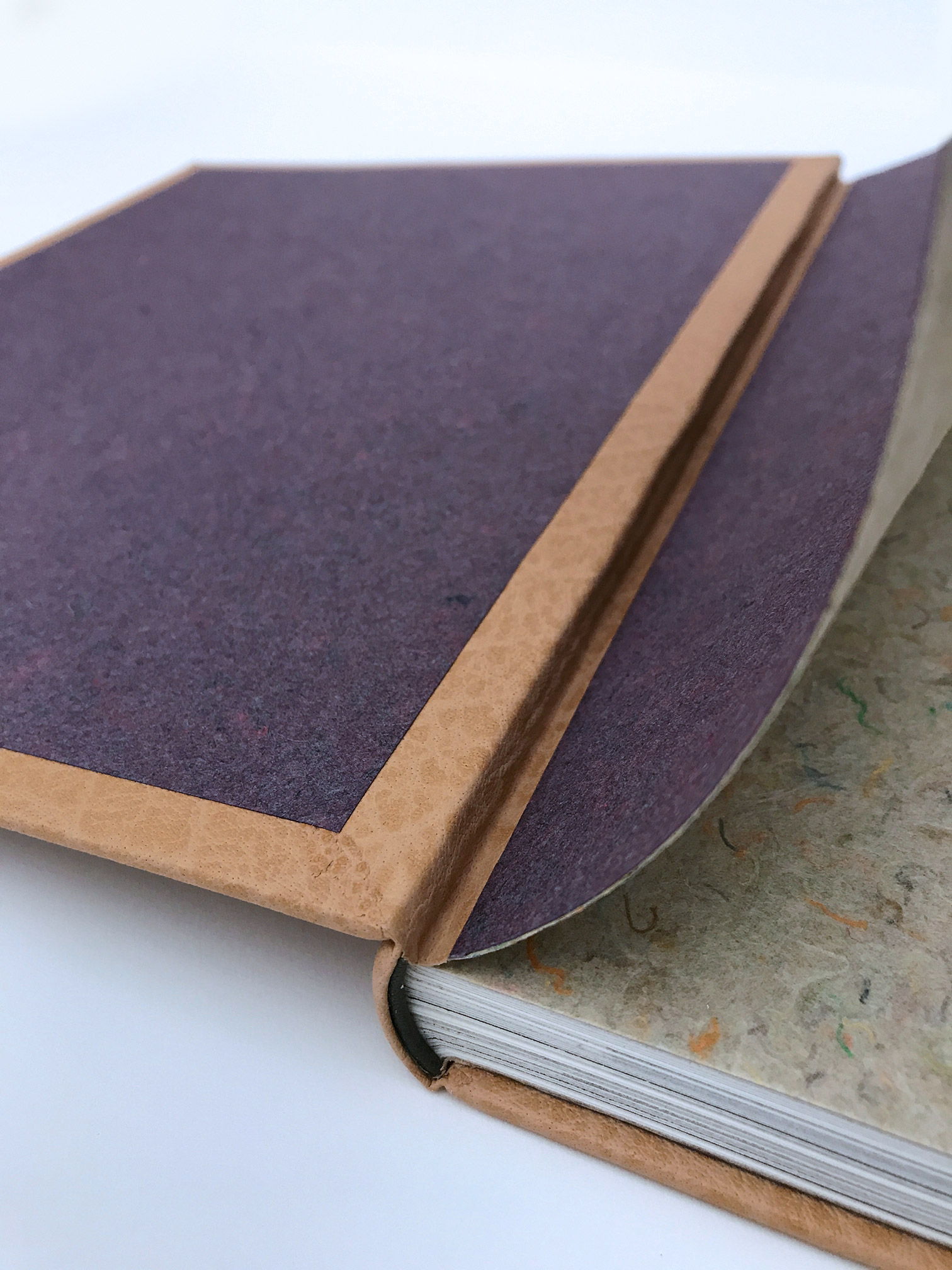 Interior of Five Hundred Years of Women’s Work binding on a white table.