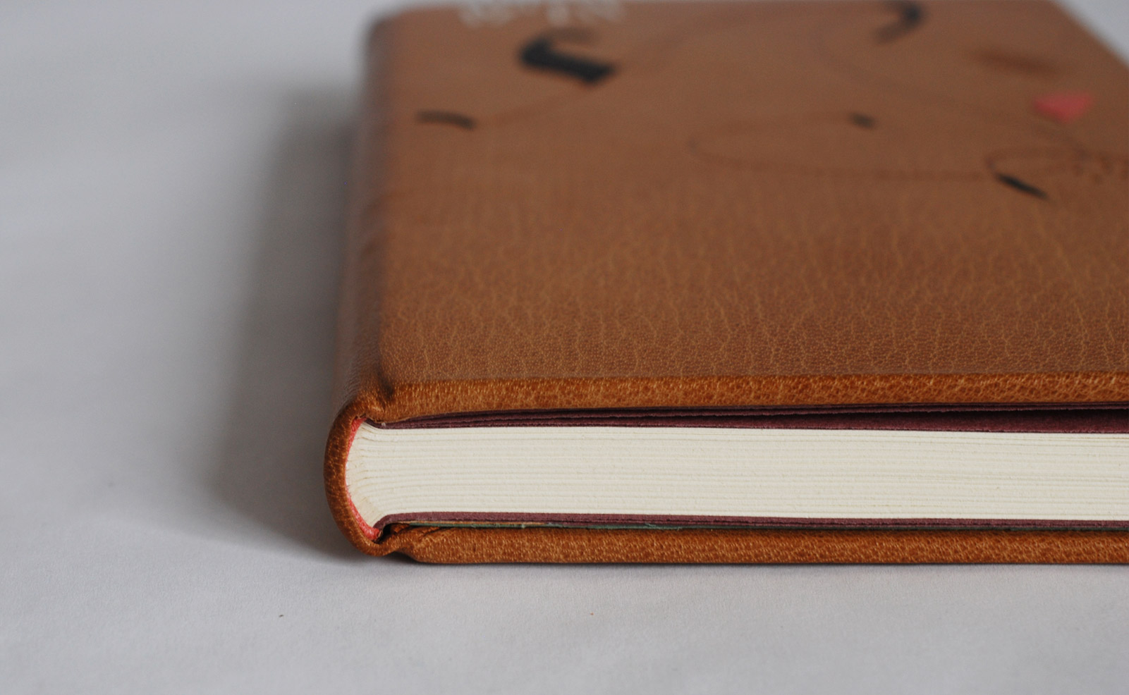 Edge of An Alphabet binding on a white table.