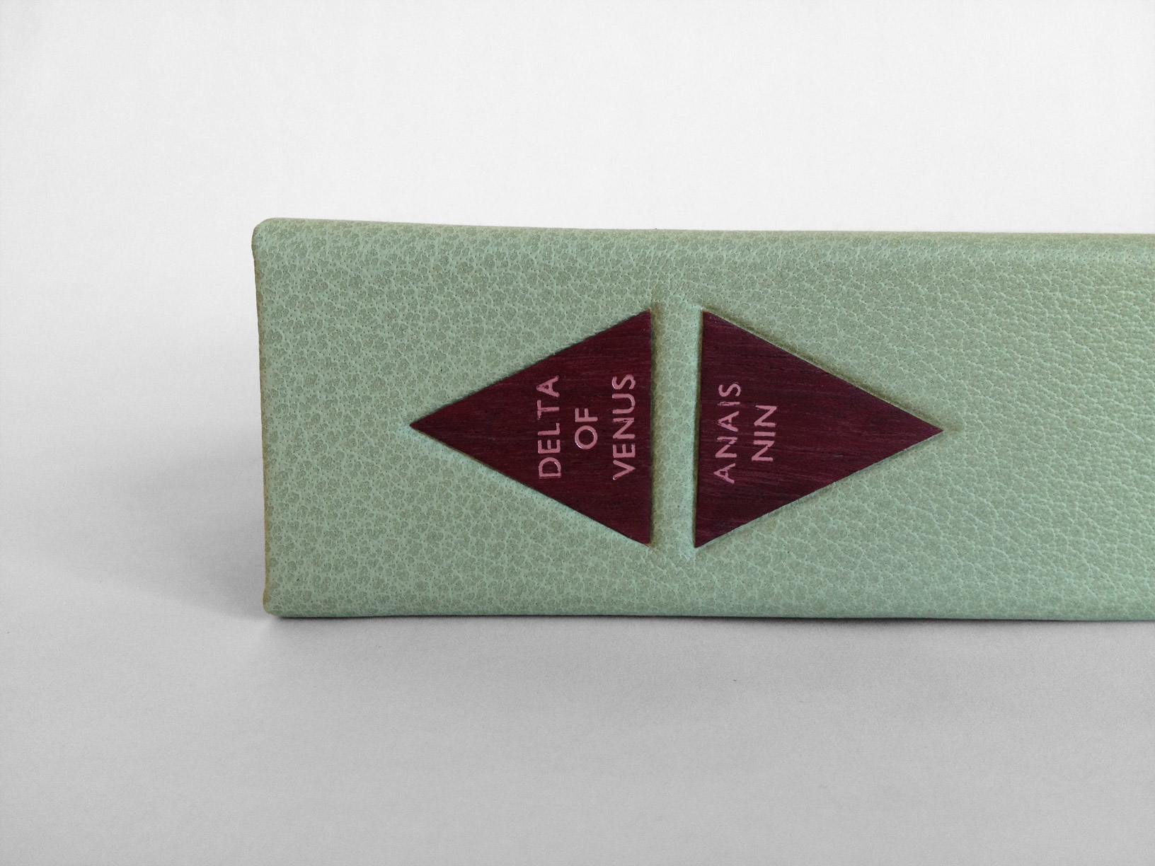 Box spine of Delta of Venus on a white table.