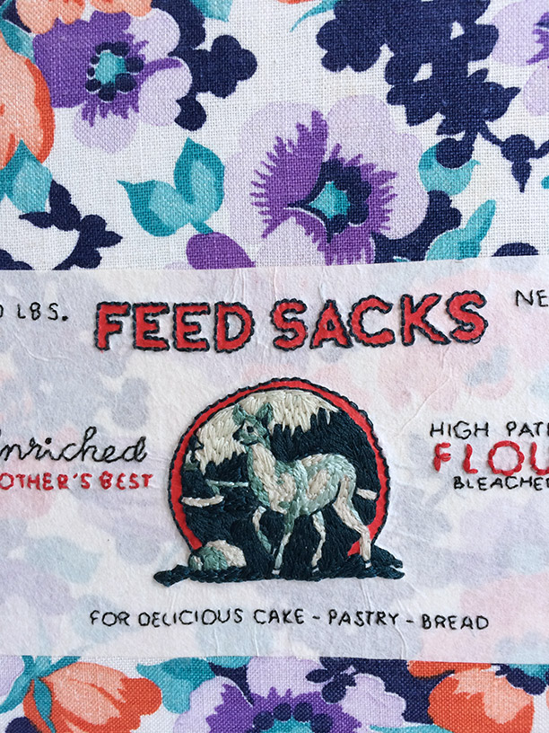 Close-up of front cover of Feed Sacks binding on a white table.