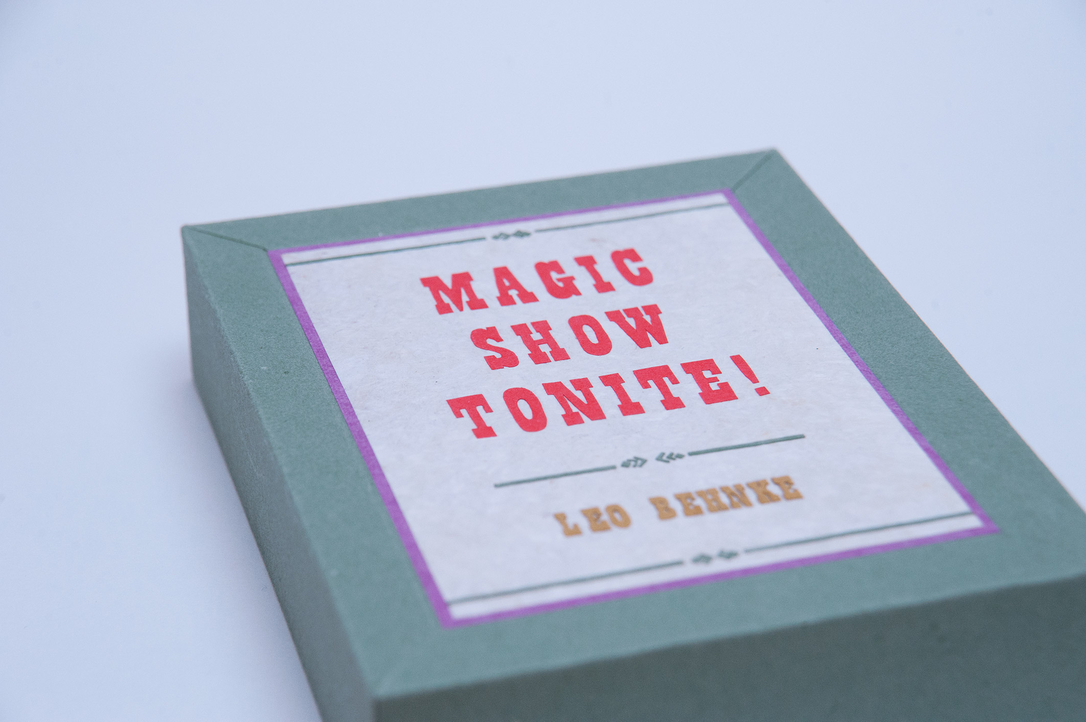 Close-up of box front cover of Magic Show Tonite binding on a white table.