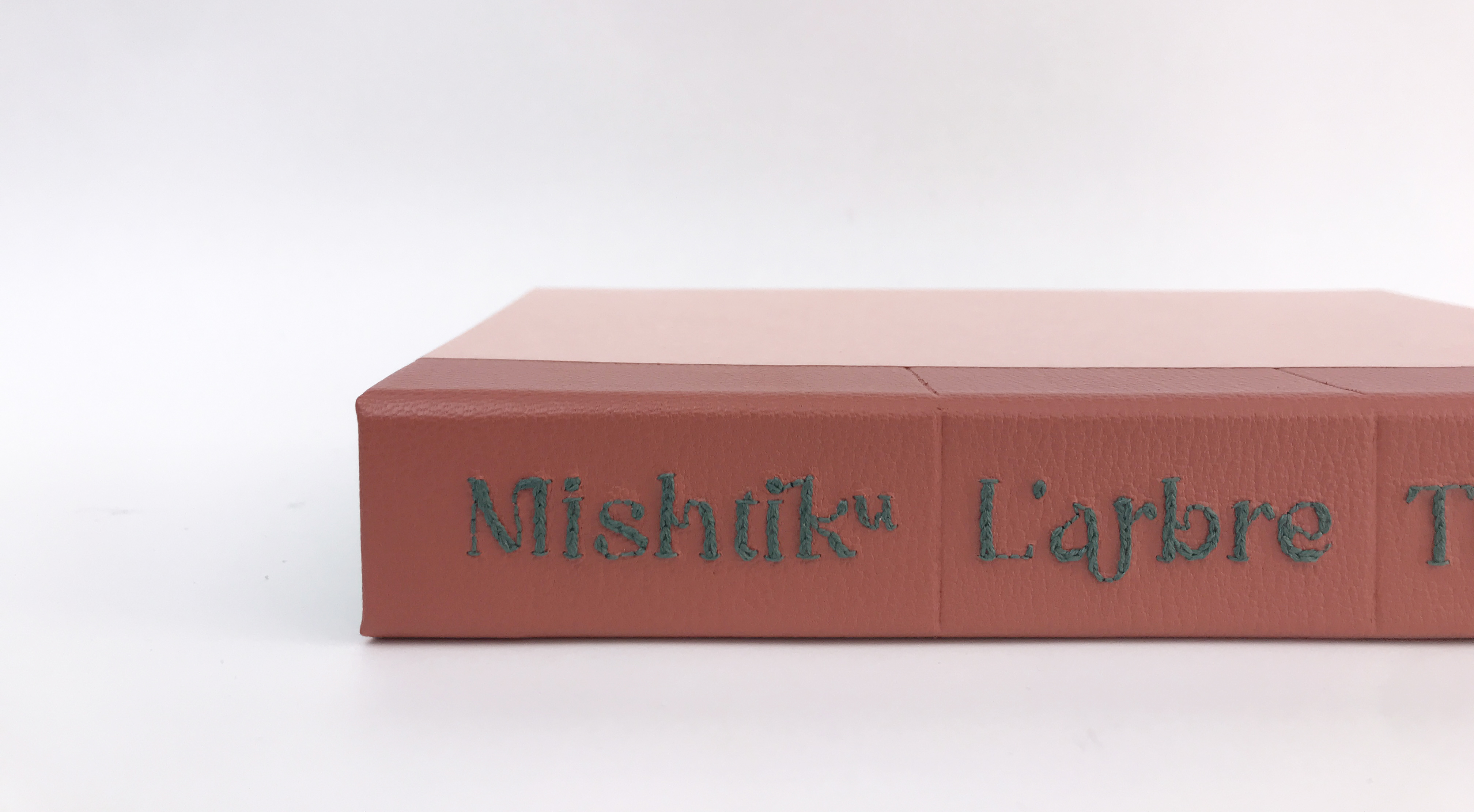 Close-up of pine of clamshell box for Mishtiku binding on a white table.