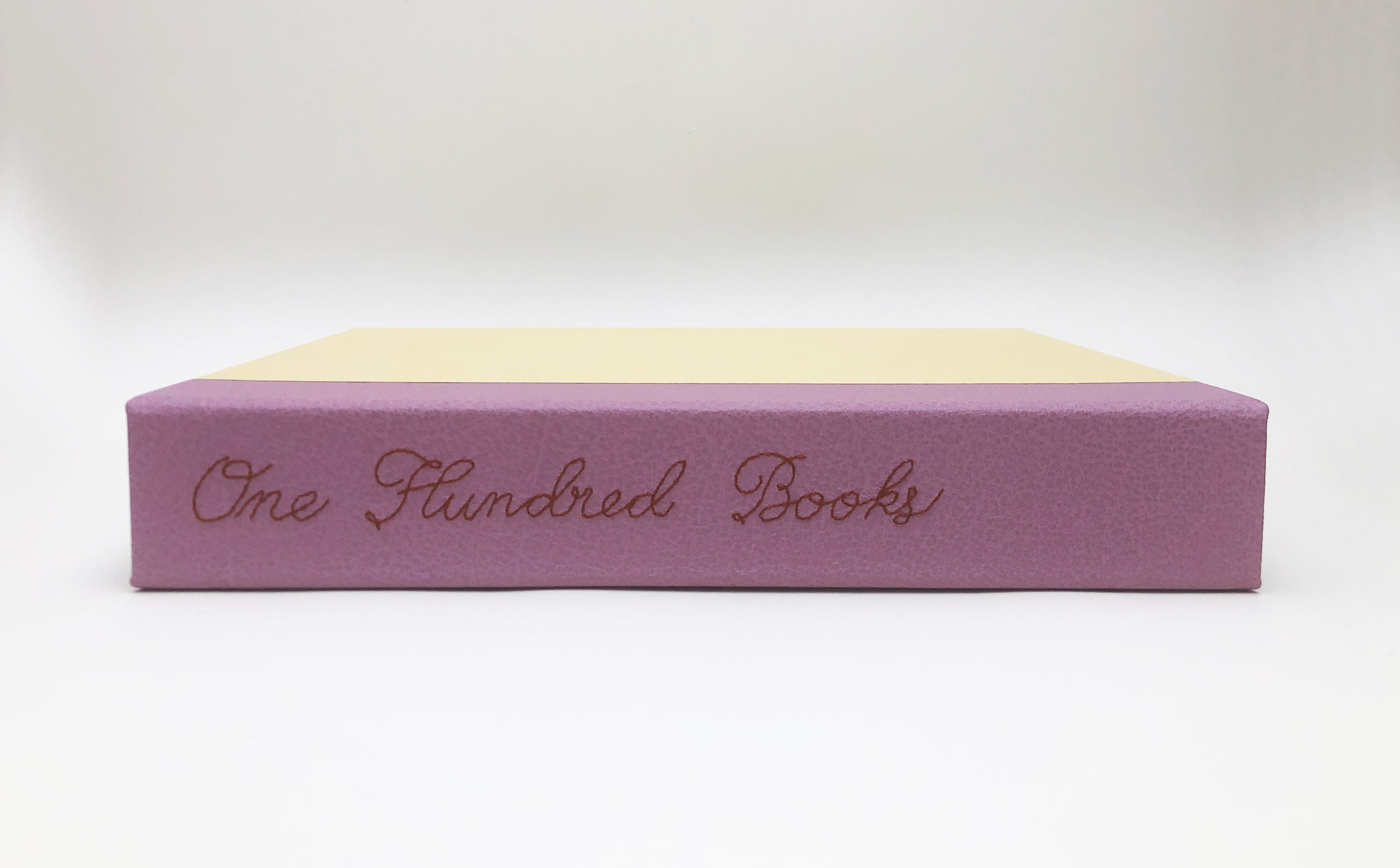 Box spine of One Hundred Books Famous in Typography binding on a white table.