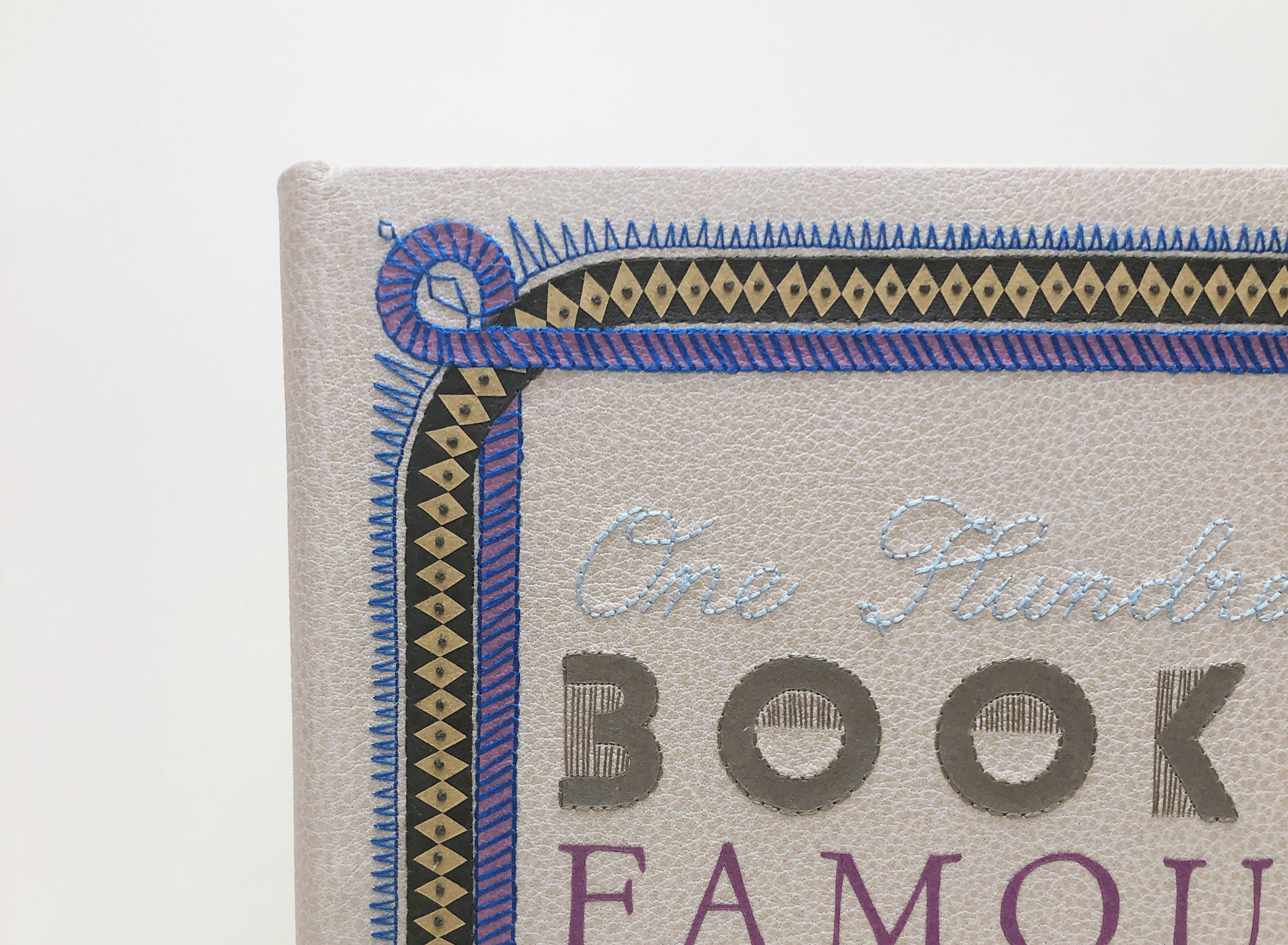 Close-up of front cover of One Hundred Books Famous in Typography binding on a white table.