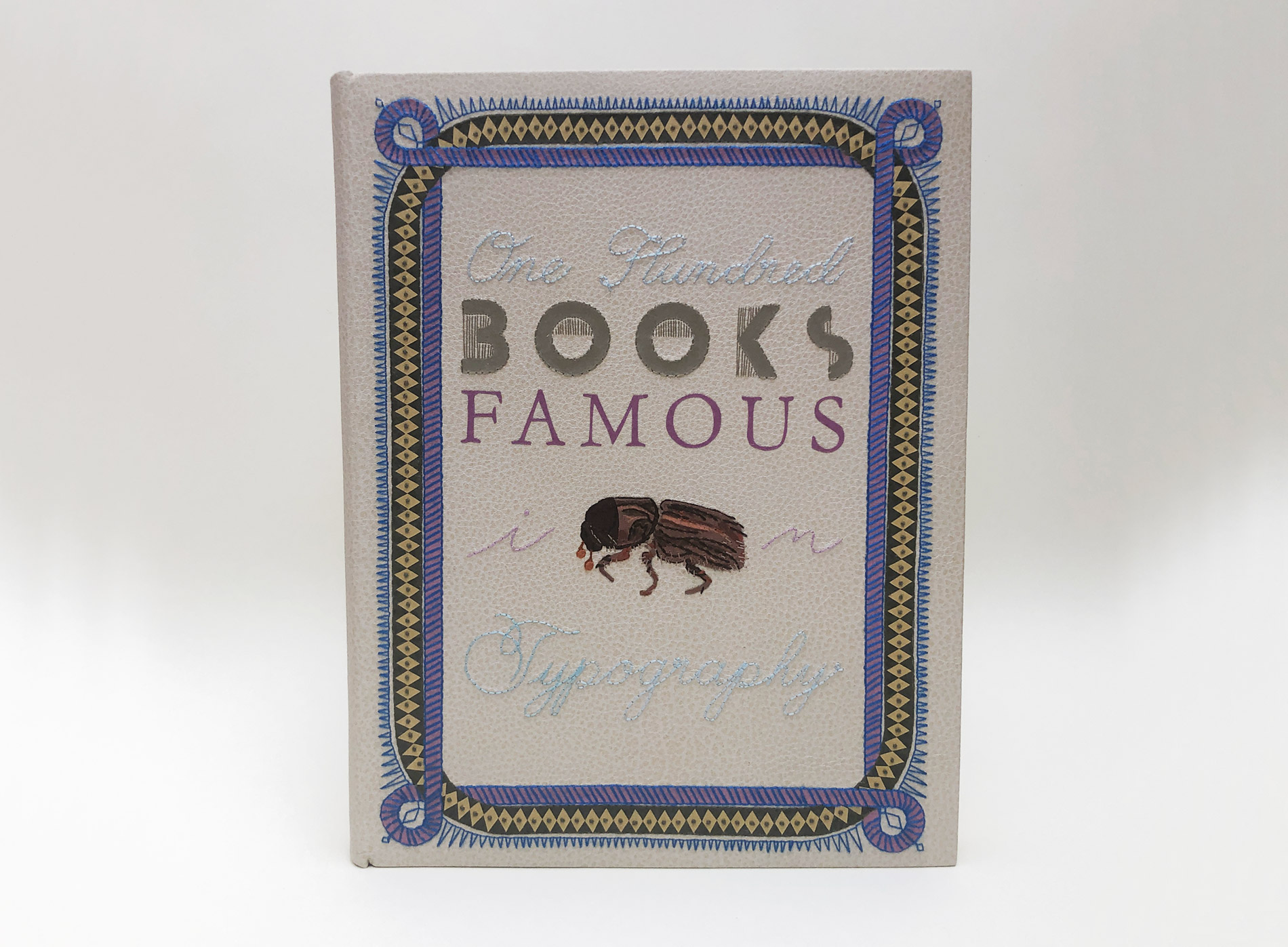 Front cover of One Hundred Books Famous in Typography binding on a white table.