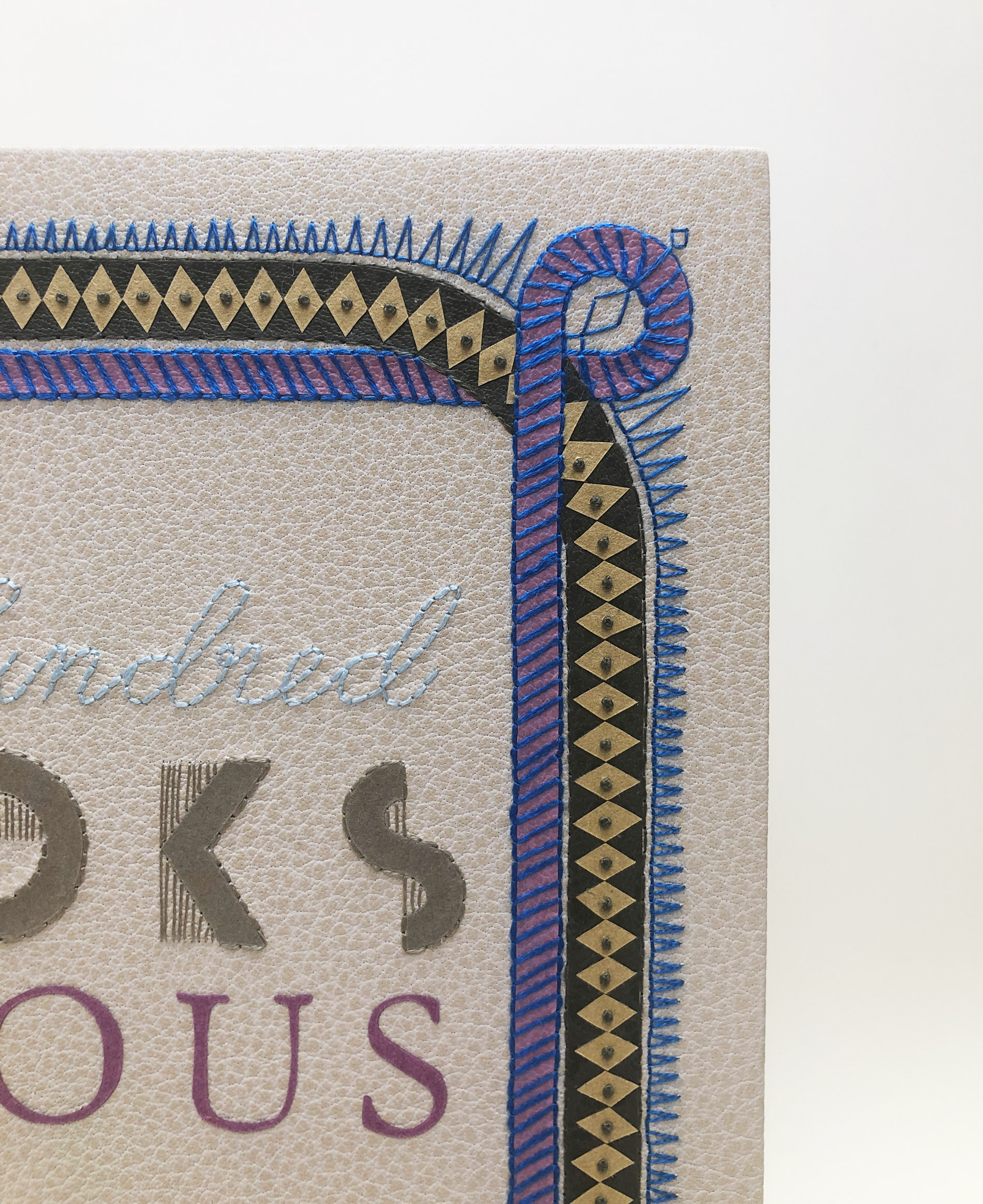 Close-up of front cover of One Hundred Books Famous in Typography binding on a white table.