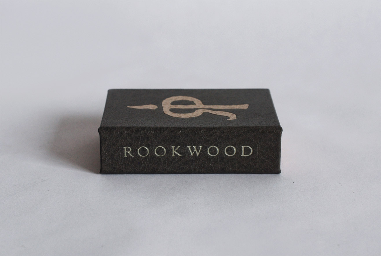 Box spine of Rookwood binding on a white table.