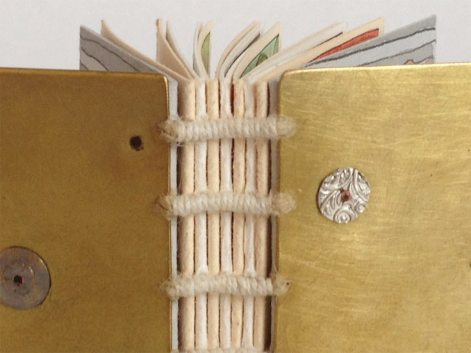 Up-close on a gold exposed spine binding.