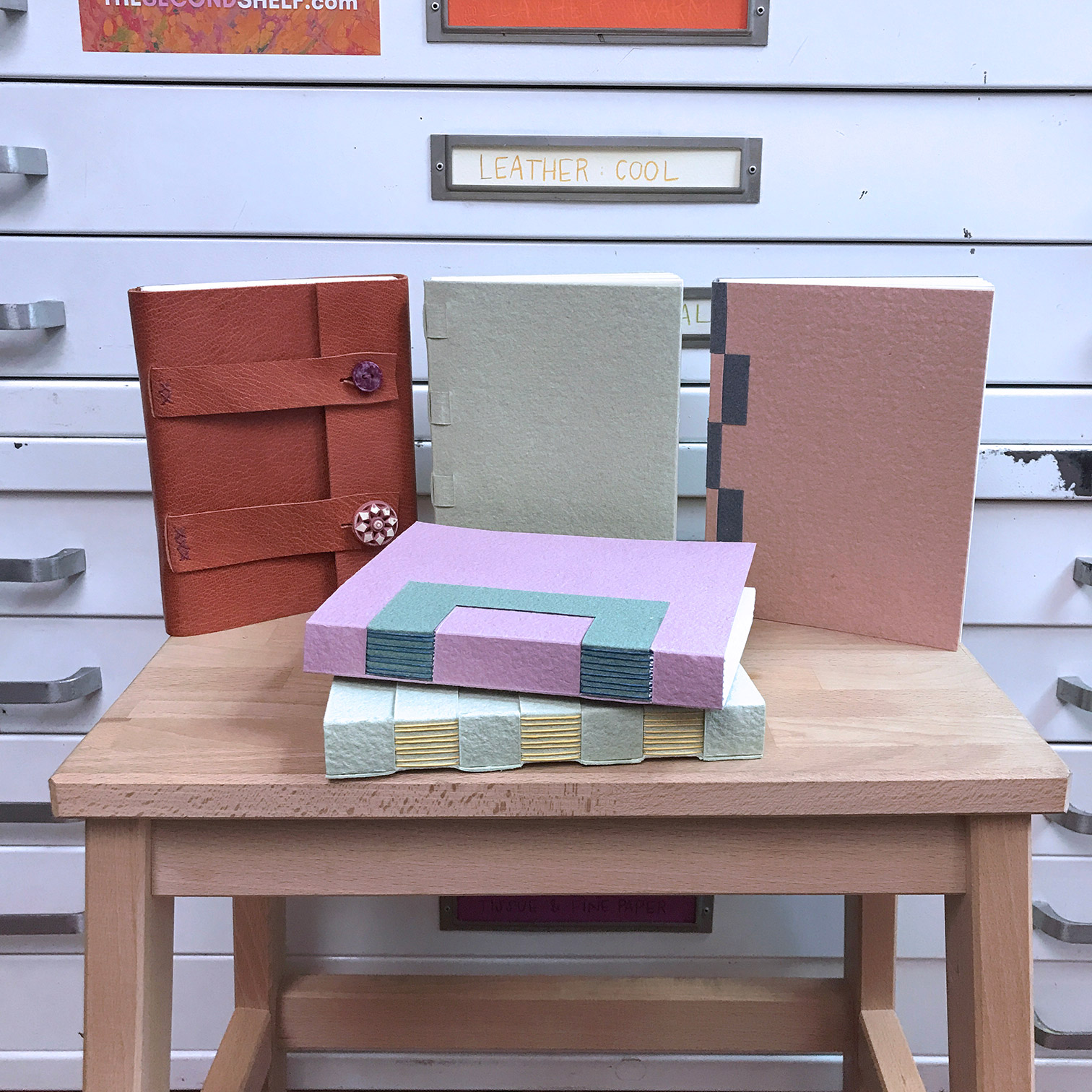 A variety of Cross Structure Bindings standing on a wooden table.