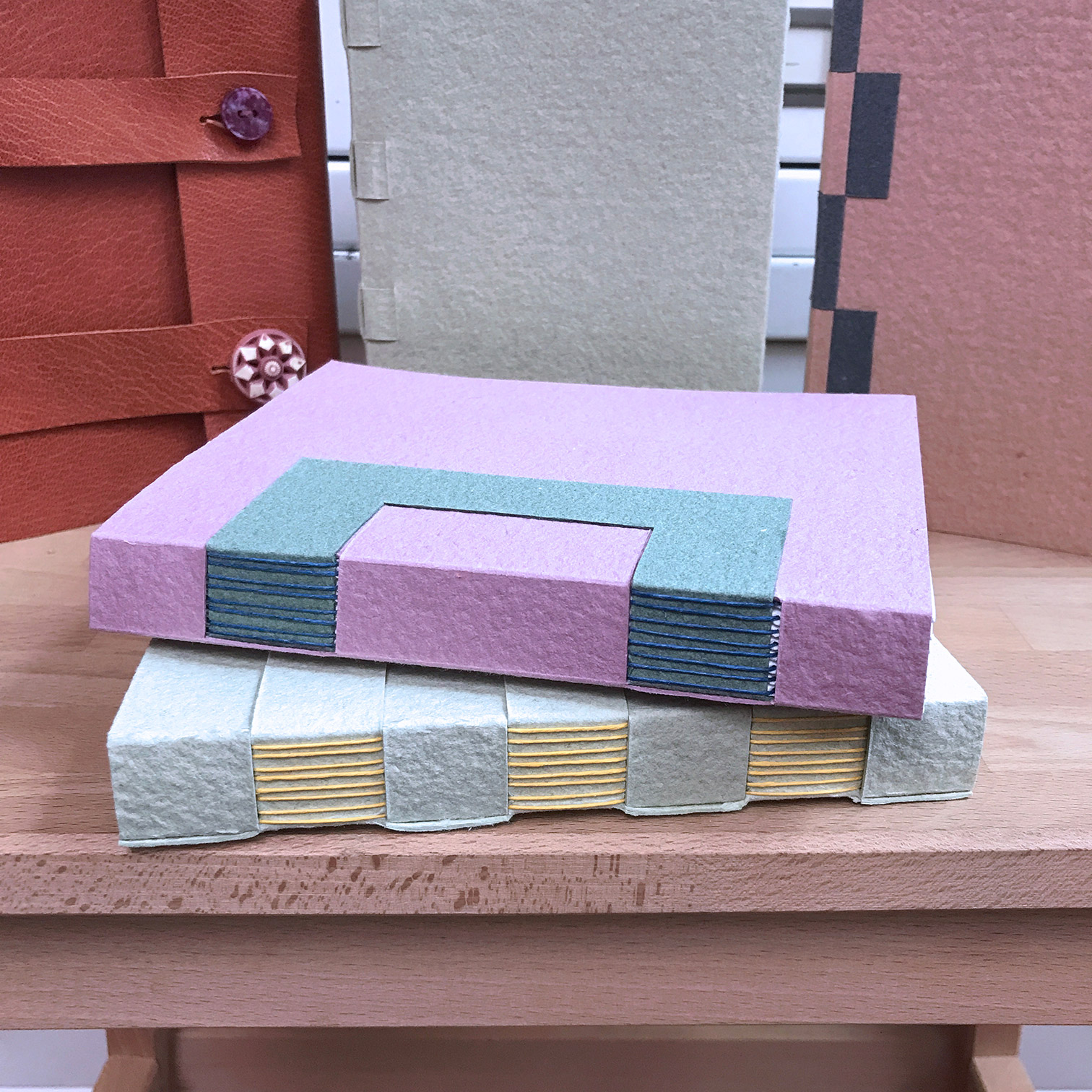 Close-up on a variety of Cross Structure Bindings standing on a wooden table.