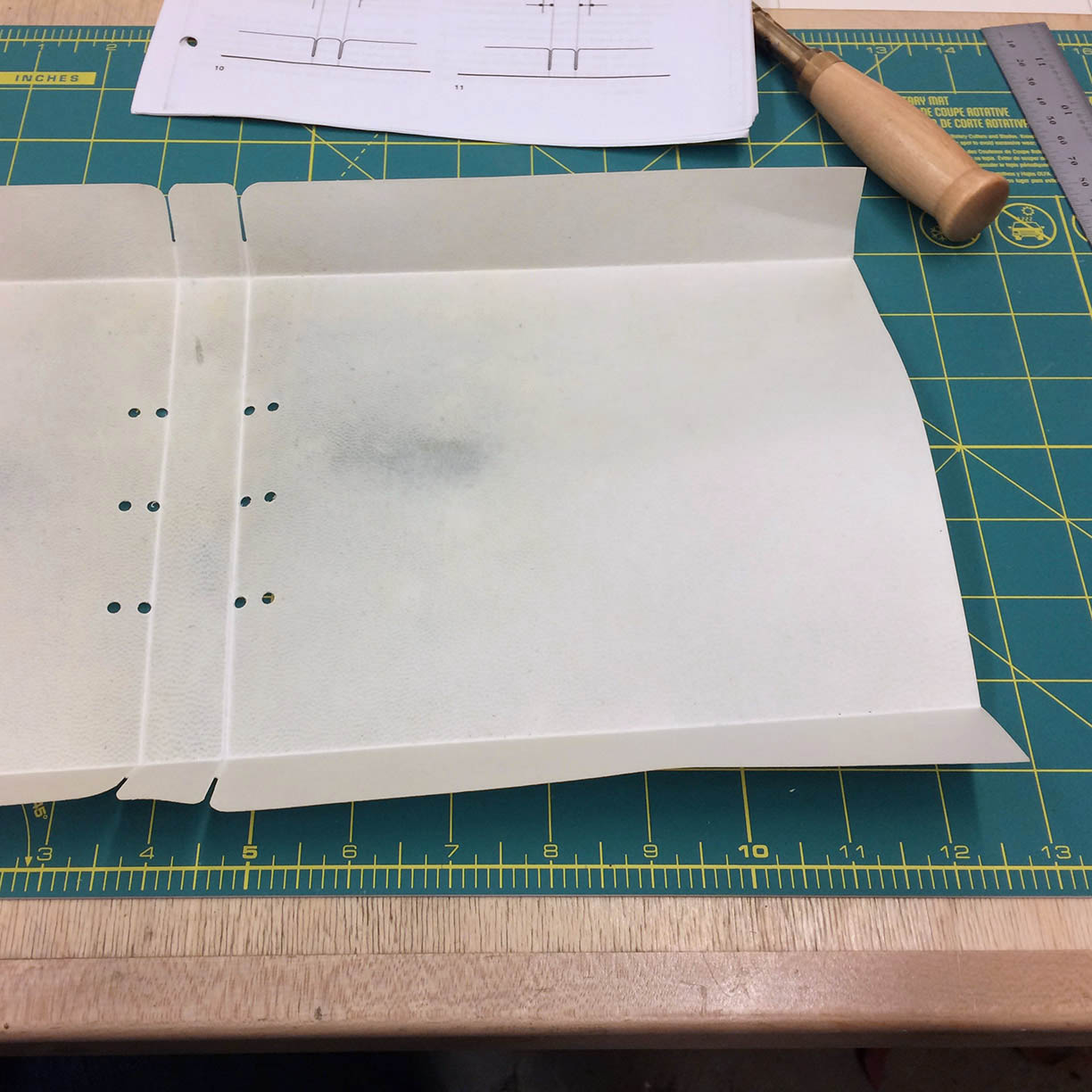 Vellum being prepared on an artists workbench.