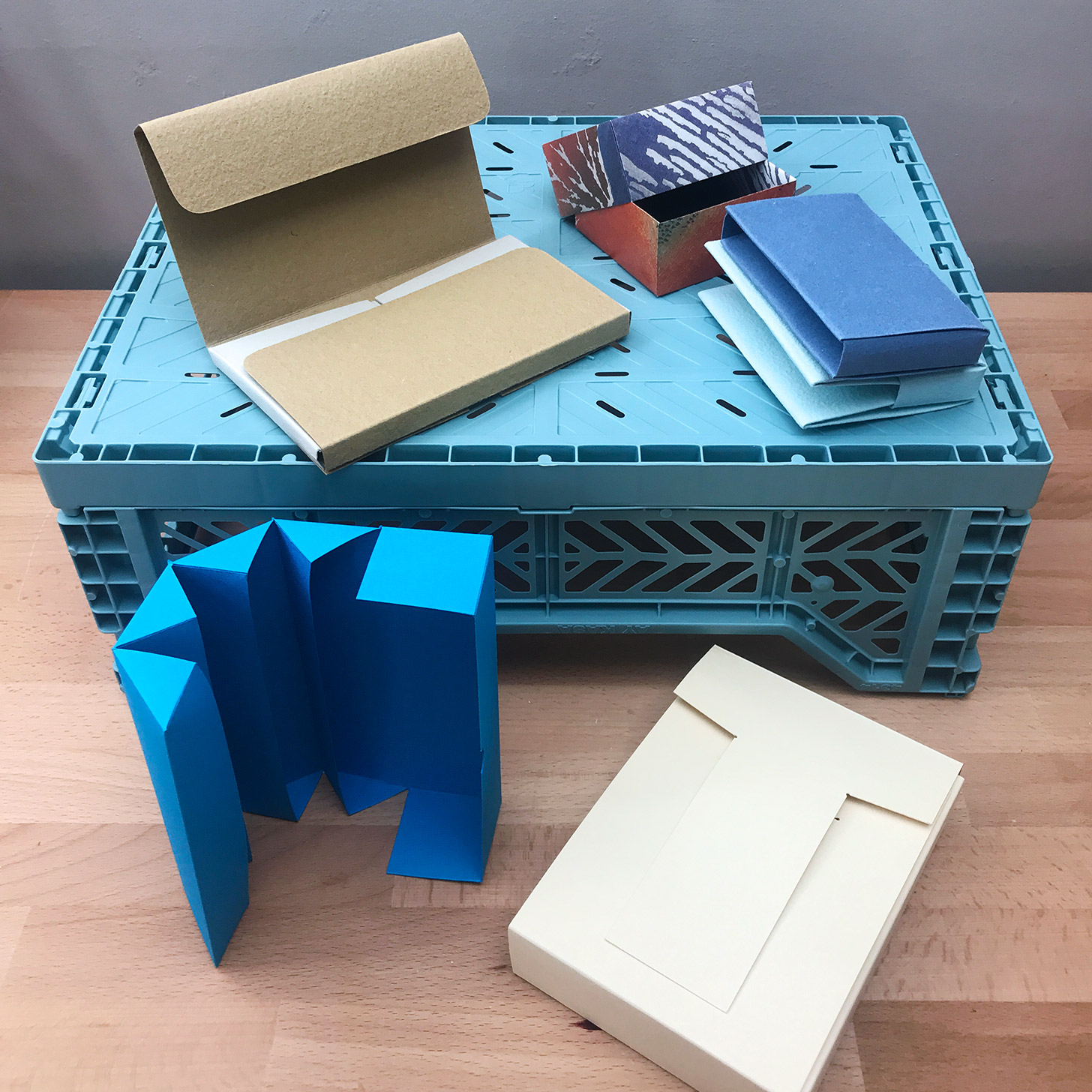 A variety of Quick Enclosures sitting on a wooden table.